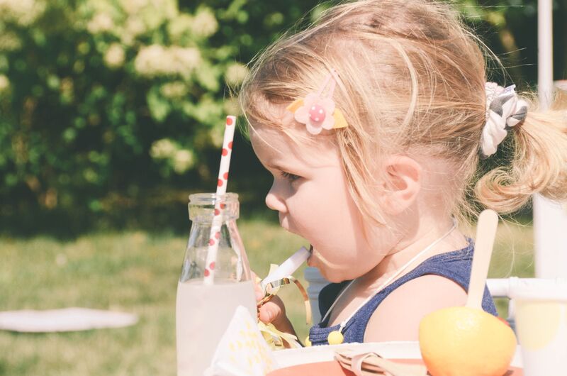 vintage juice glass with paper straw with girl and noise maker